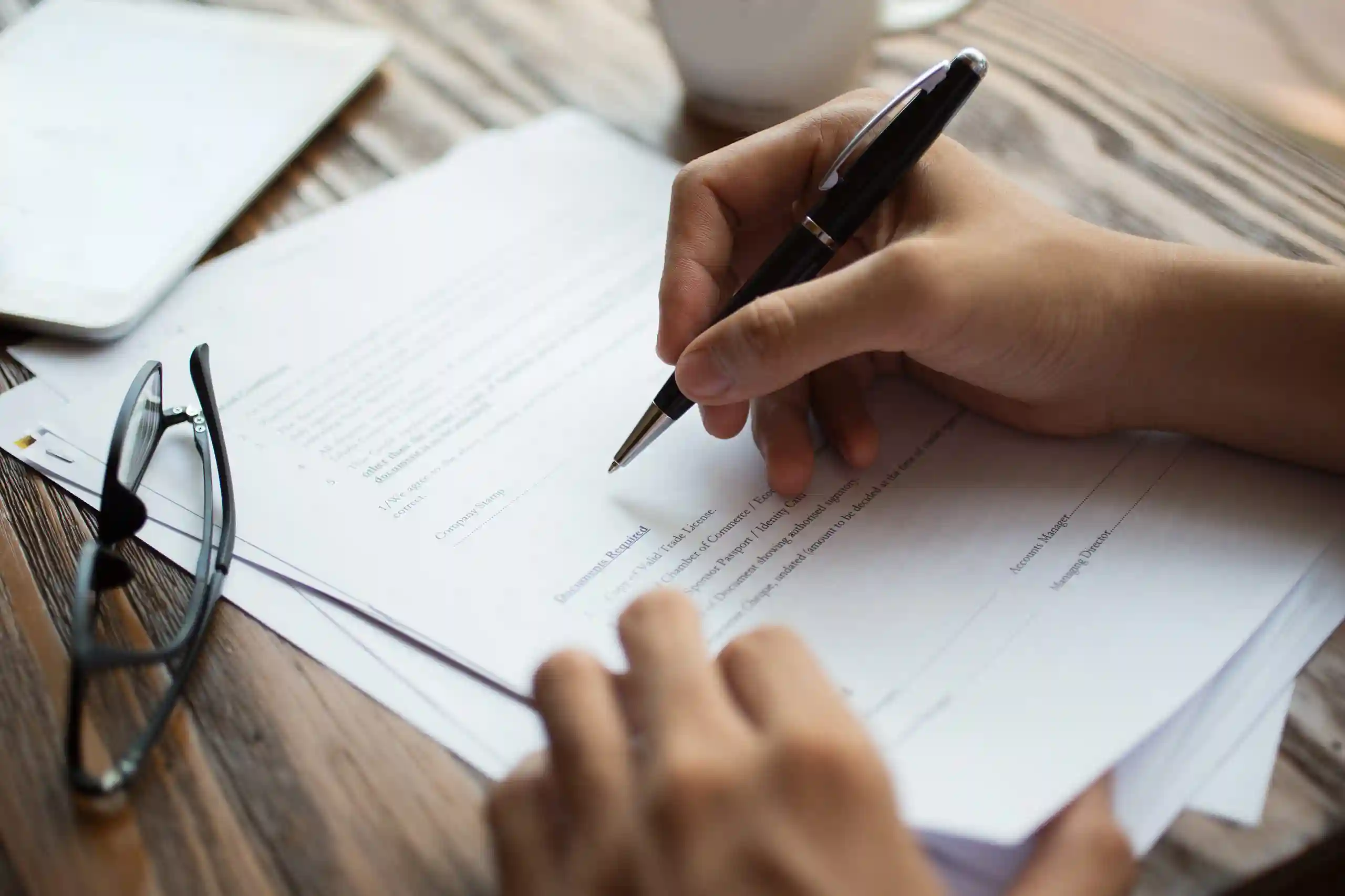 businessman-examining-papers-table-scaled