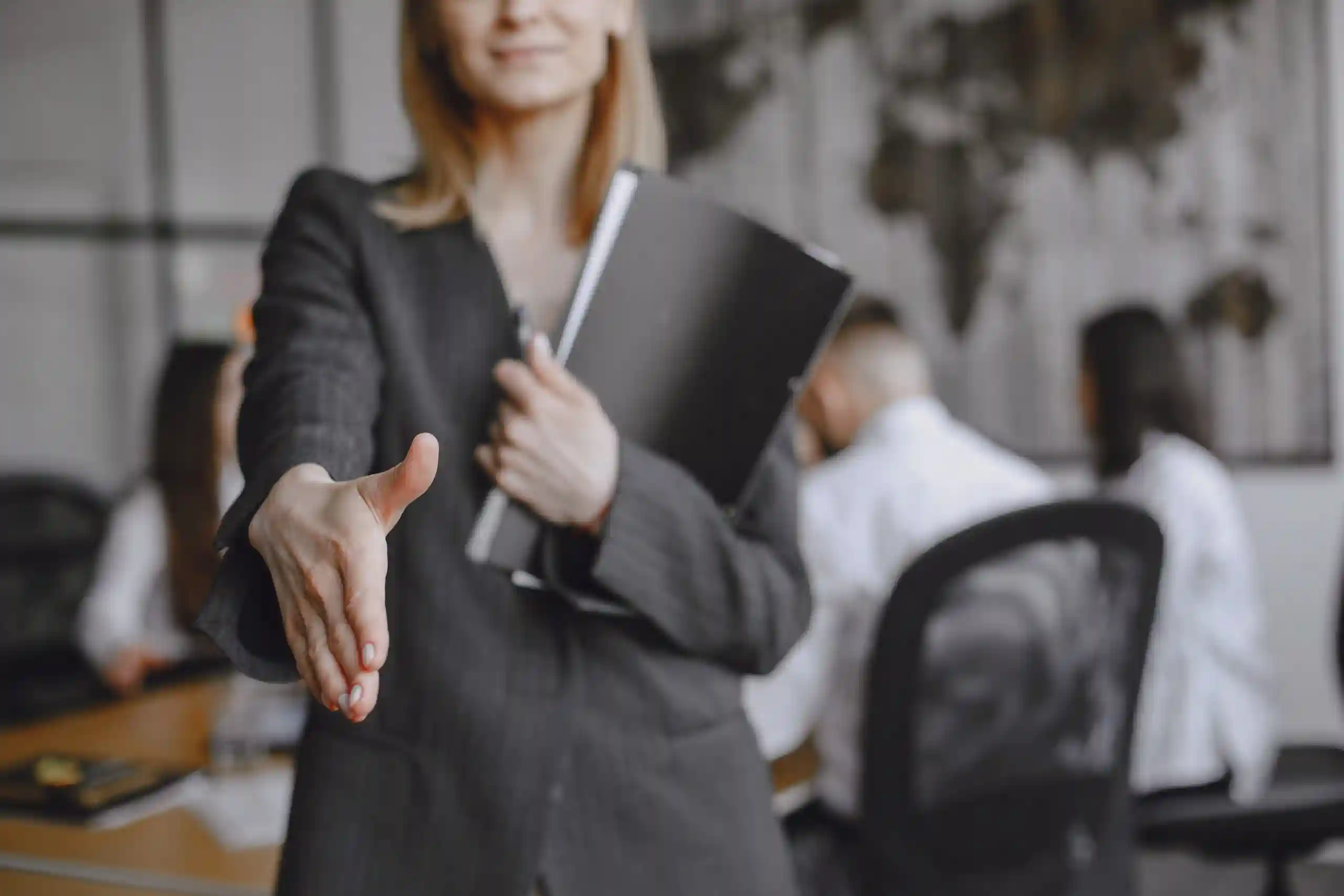 girl-signs-documents-lady-sitting-table-manager-working-office-scaled